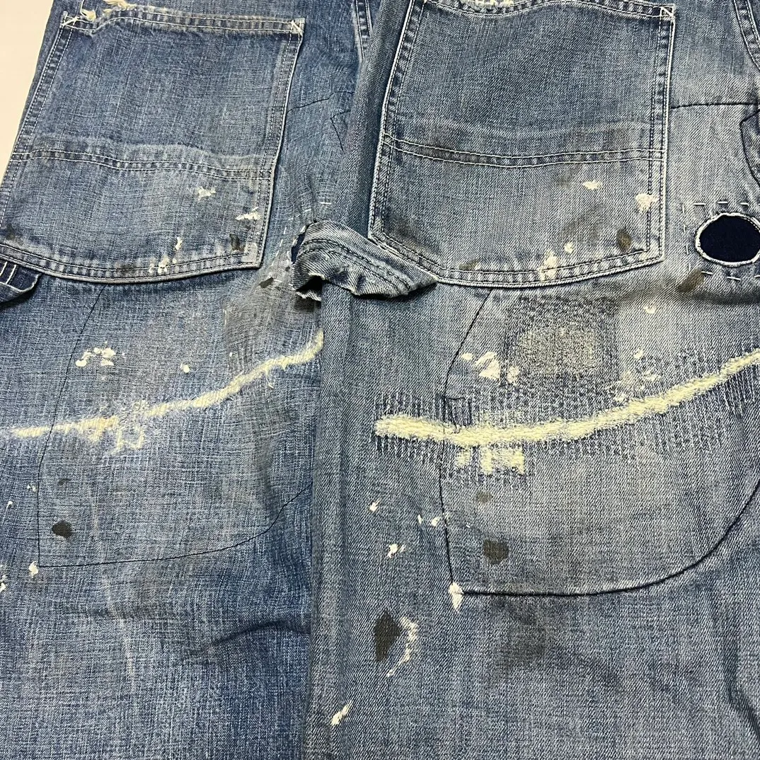 Proofing VS ZP SAINT Mxxxxxx SAINT_DENIM PANTS/PAINTER /BLUE Knife cut holes and splashed ink logging trousers Patch jeans Blue S-XL All accessories are molded and customized Super heavy work Washed and worn Knife cut holes Artificial ink splashed graffiti Genuine version Loose and stylish